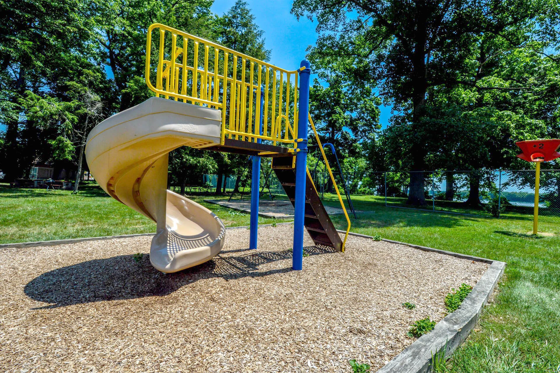Playground area at Delaire Landing Apartments on a sunny summer day